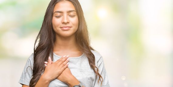 Une femme avec les mains sur la poitrine