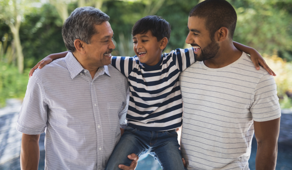 A kid in between two men