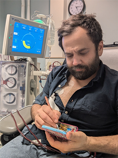 Nikolas painting in his hospital bed