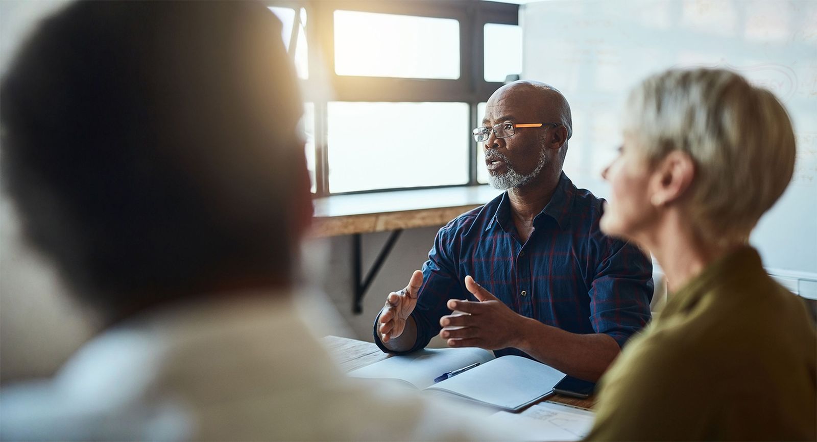 Group of adults sitting at a table having a discussion