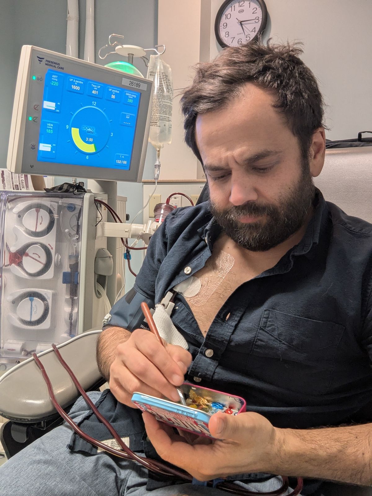 Nikolas painting in his hospital bed