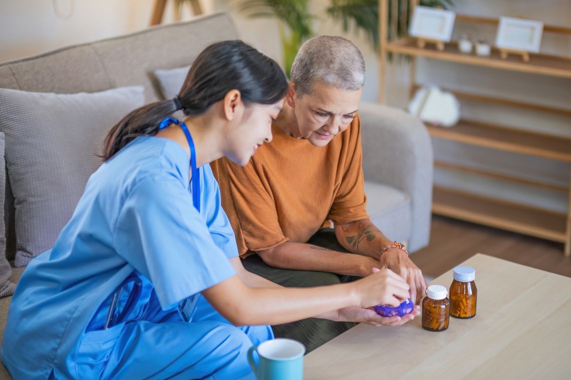 A doctor talking with a patient with medication on a coffee table