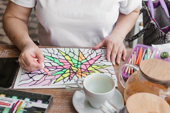 Woman making an art piece with coloured pencils